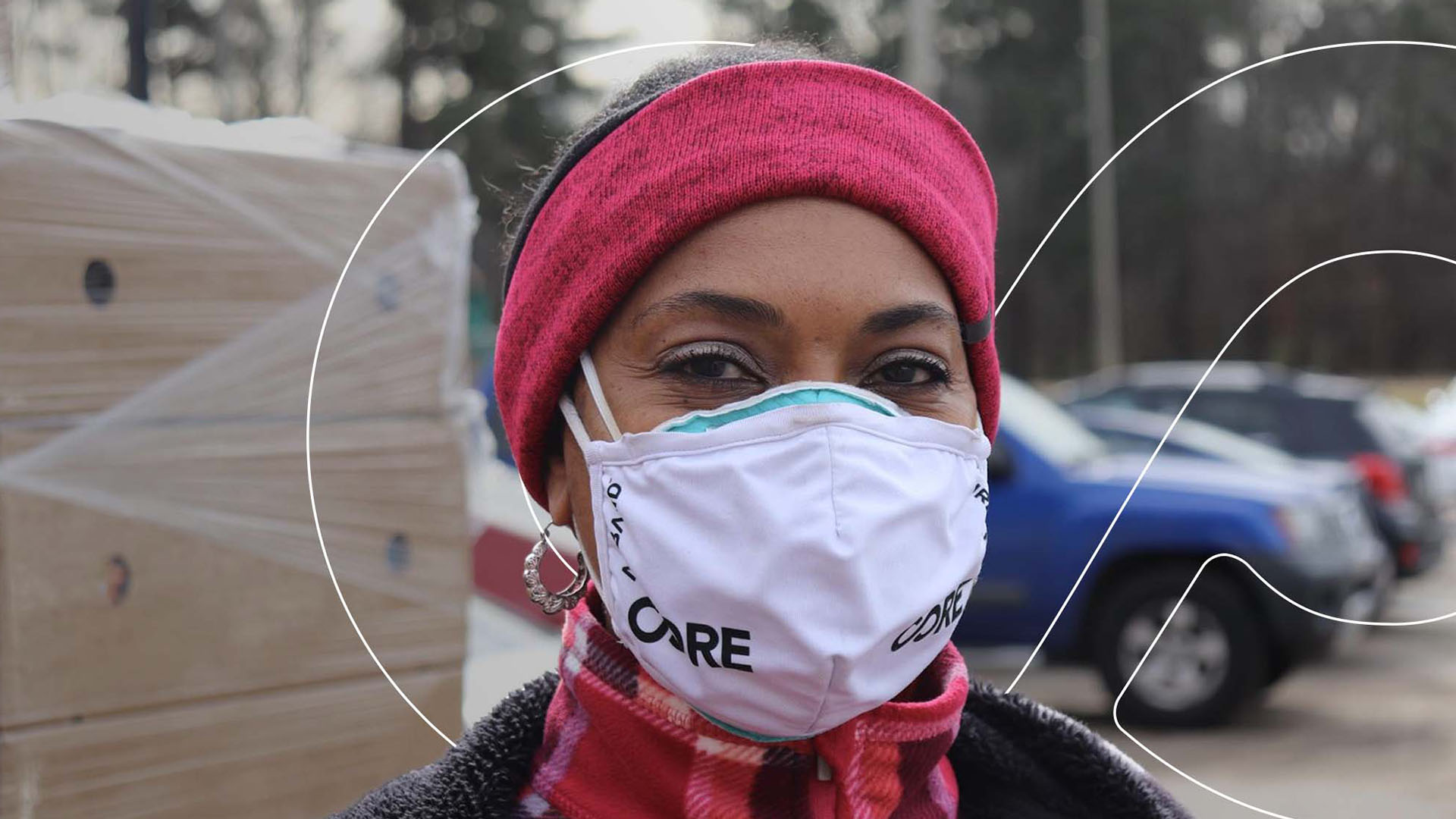 A woman wearing a facemask poses for a picture.