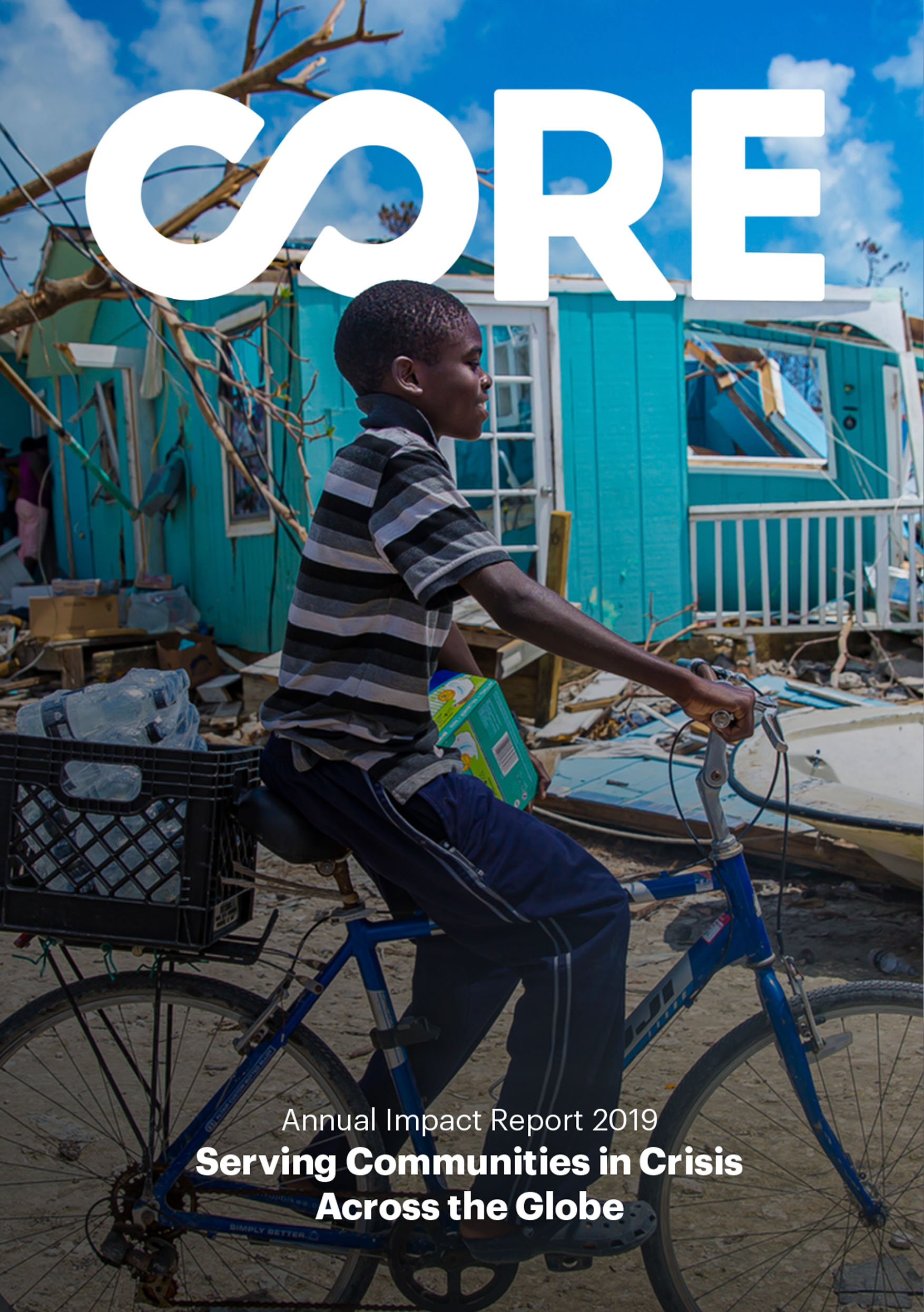 A cover photo of CORE's 2019 Impact Report. A boy riding on his bike past a blue house that was damaged in a hurricane.