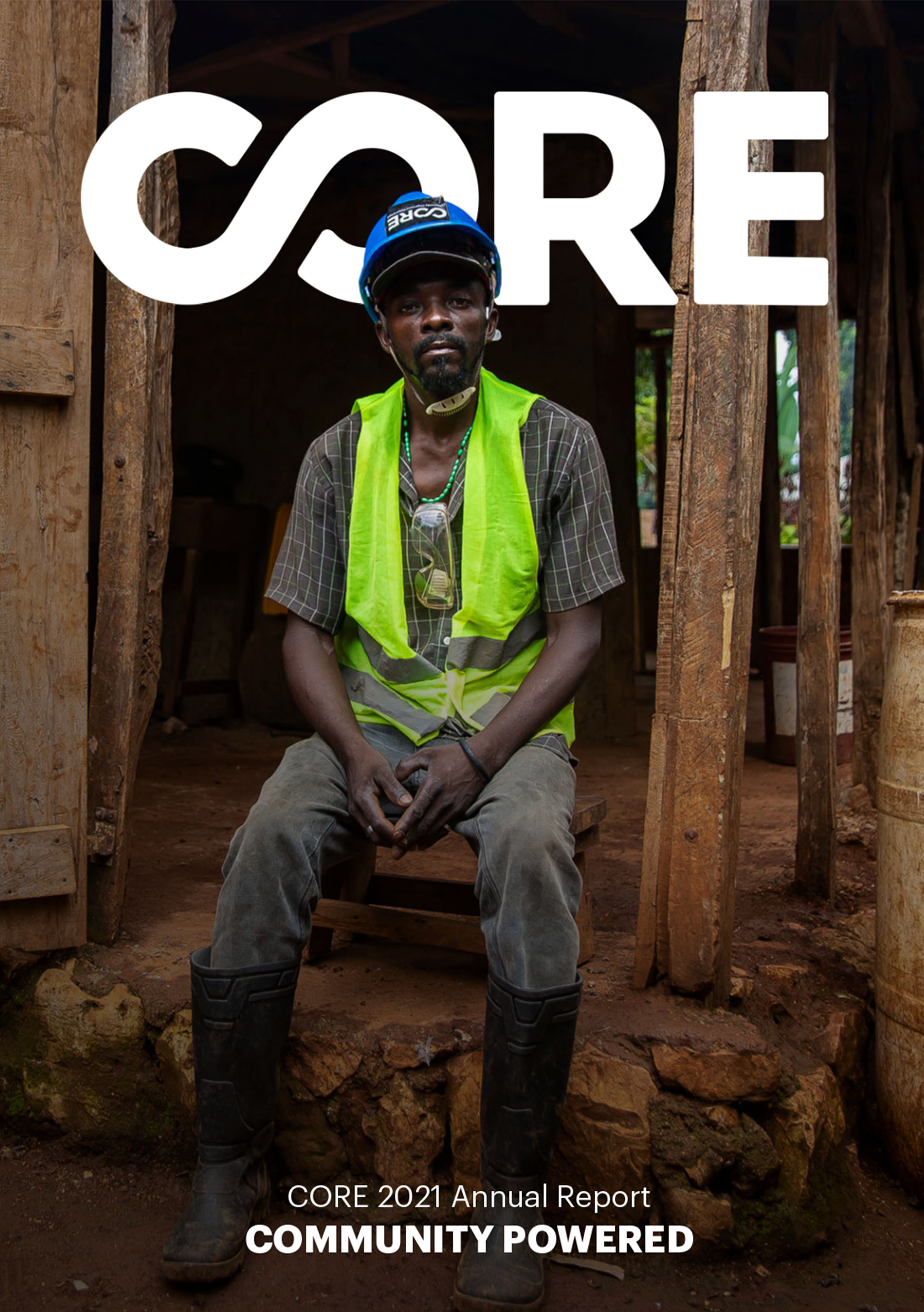 Cover image from CORE's 2021 impact report. A man sitting inside of home under construction.