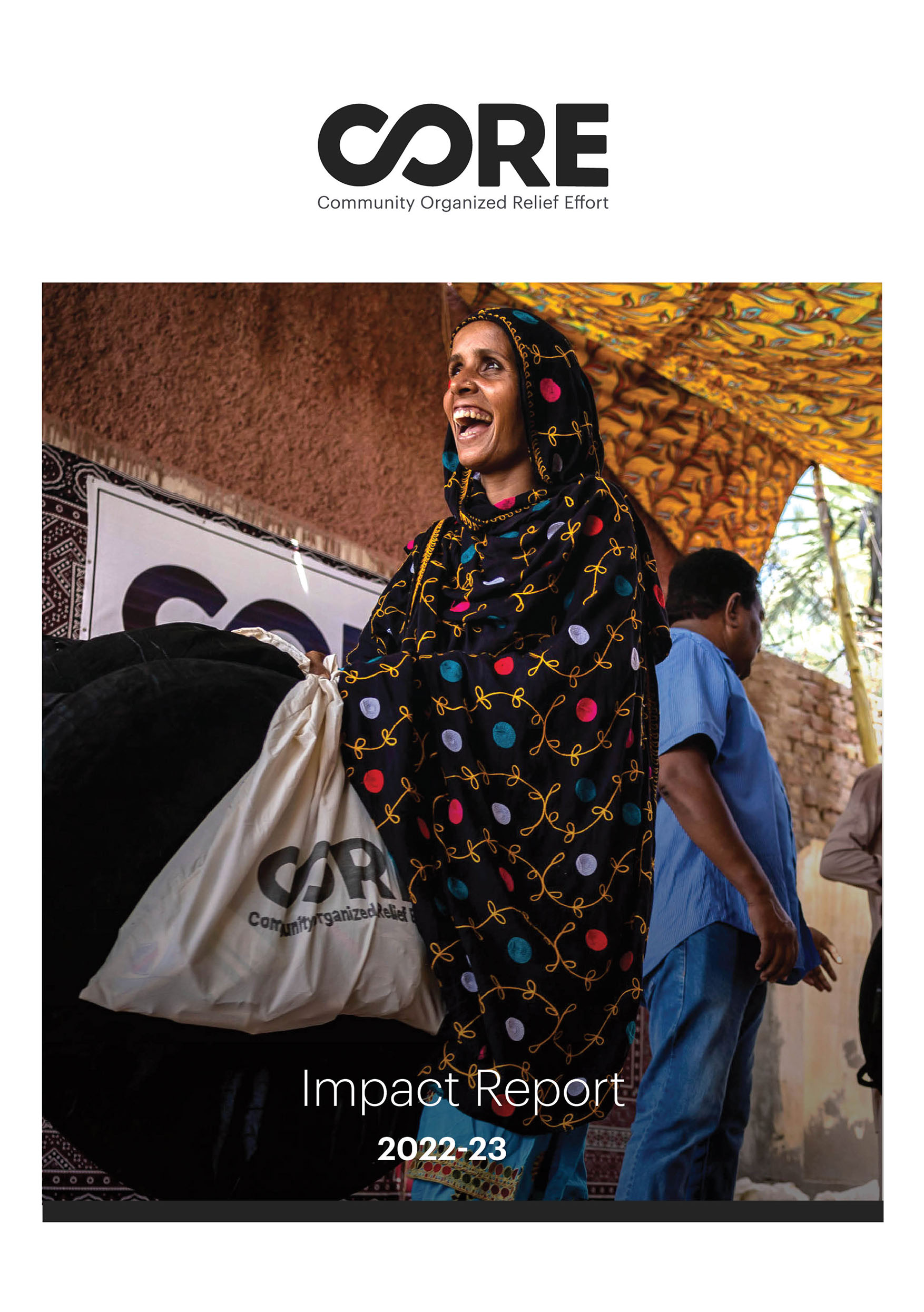 Impact Report 2022-23 cover photo. CORE Beneficiary carrying supplies after the flood in Pakistan