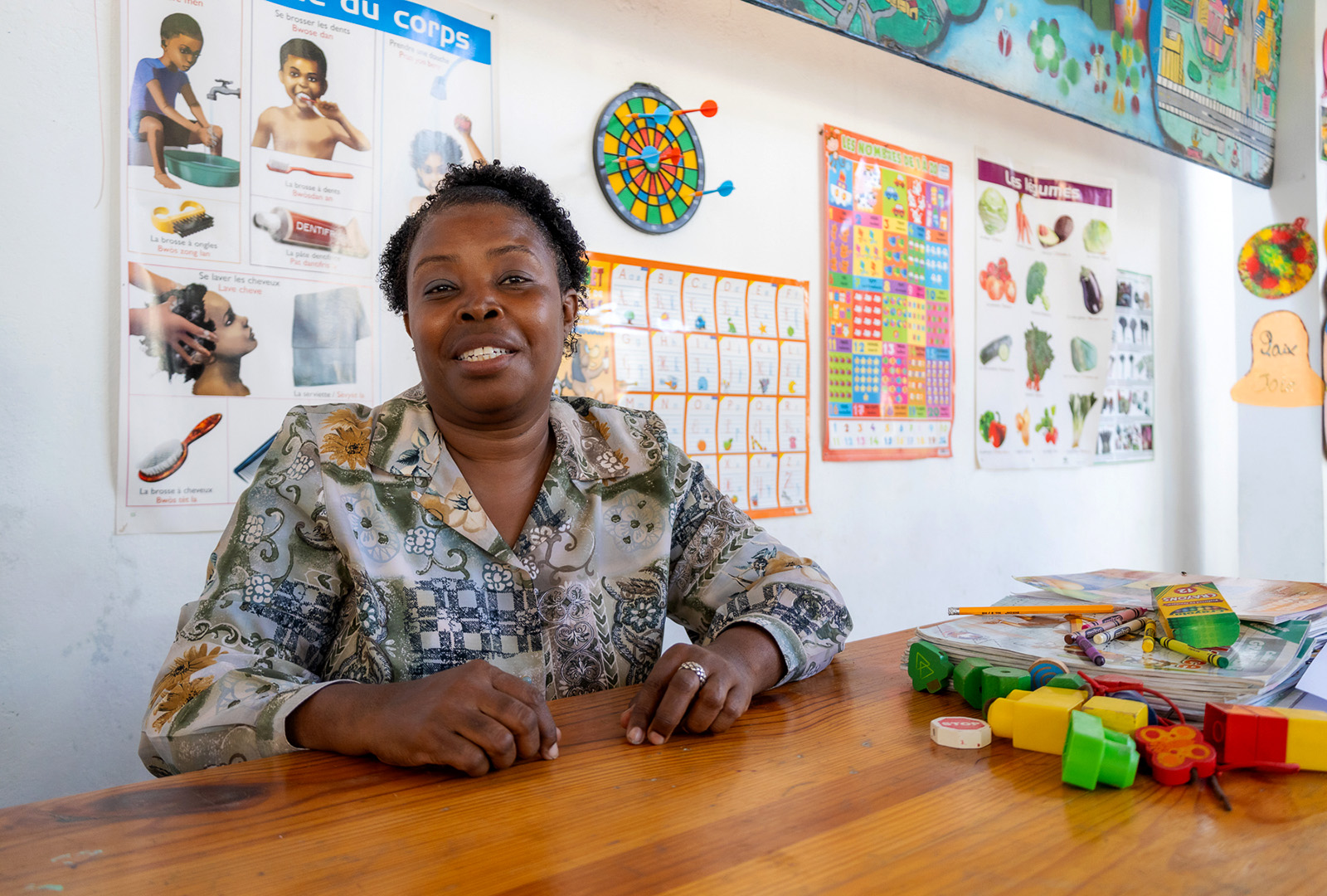 Natacha Jason Pierre, a teacher at the School of Hope and Sunshine, poses for a photo inside of her classroom.