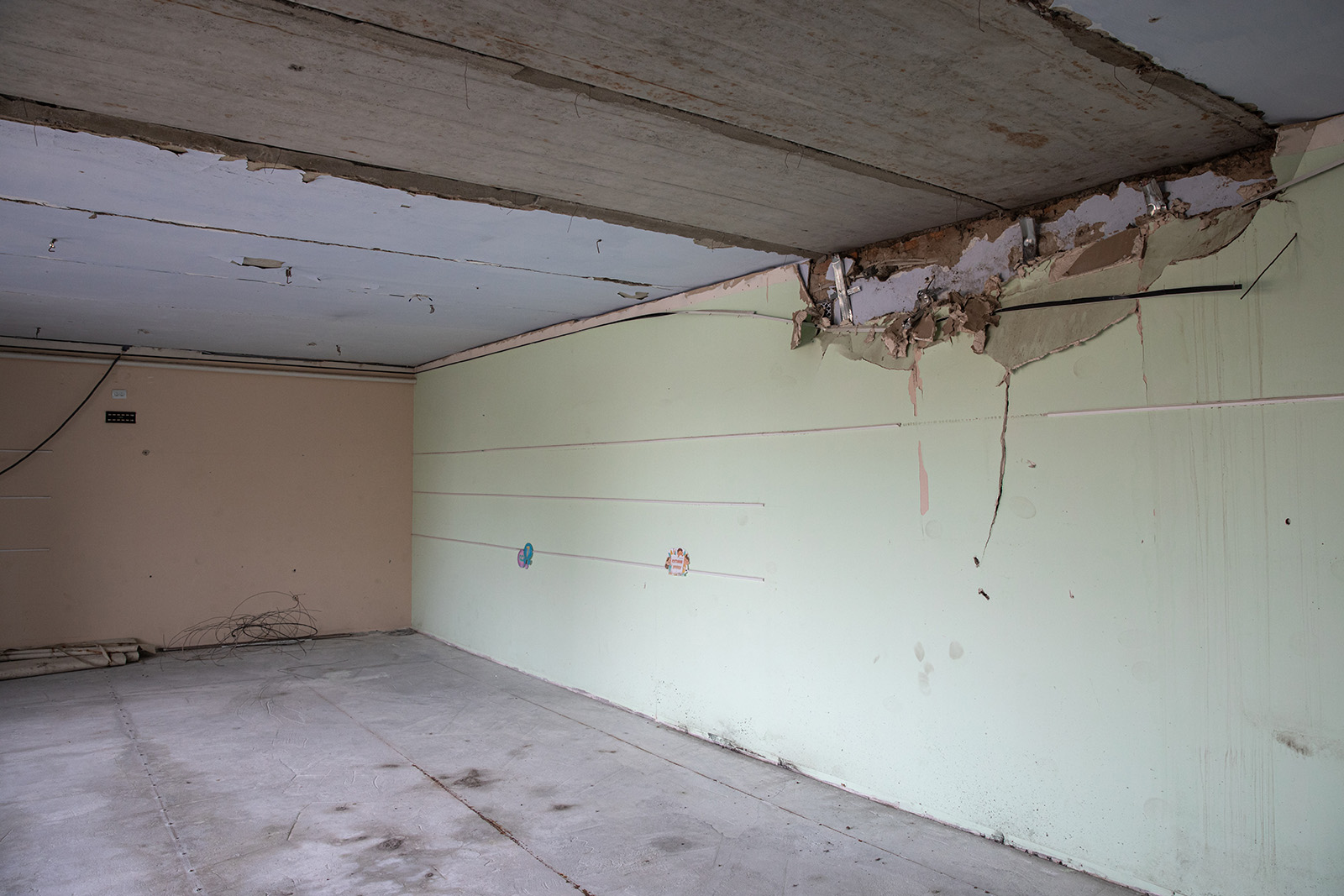 empty classroom with wall and ceiling damage