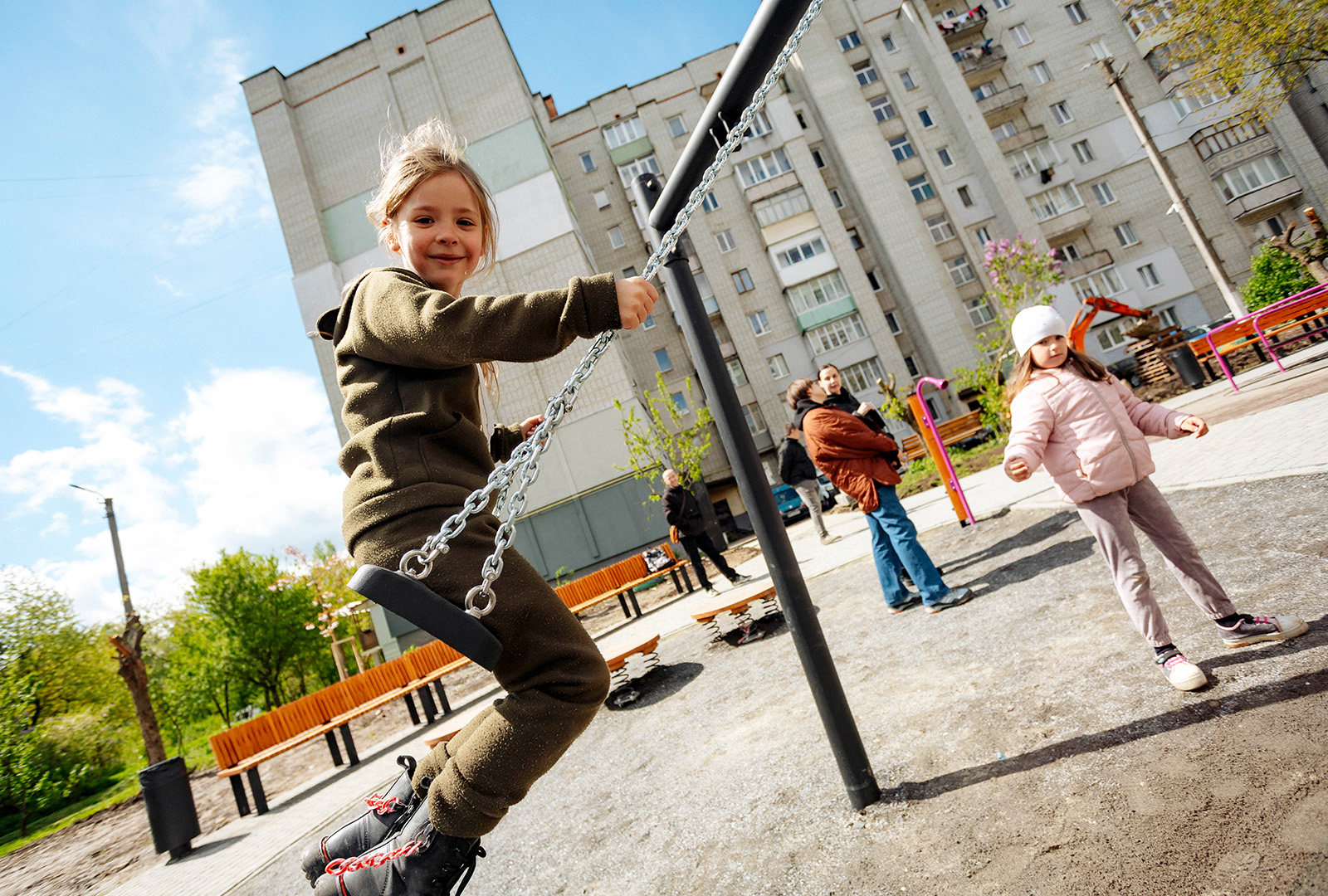 A young girl on a swing in the new playground build in the Ukrainian town of Stebnyk.