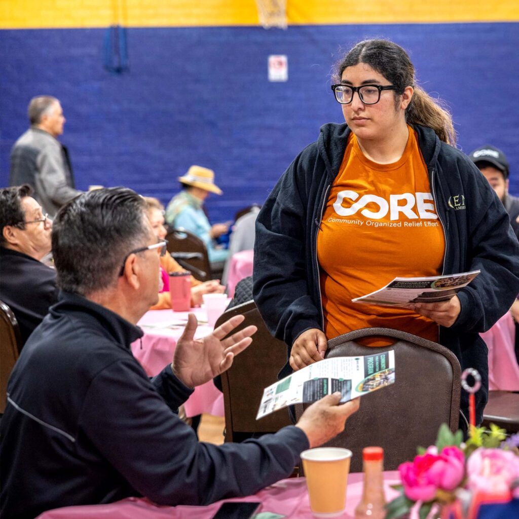 CORE Staff talking to one of our beneficiary in our Health Program access.