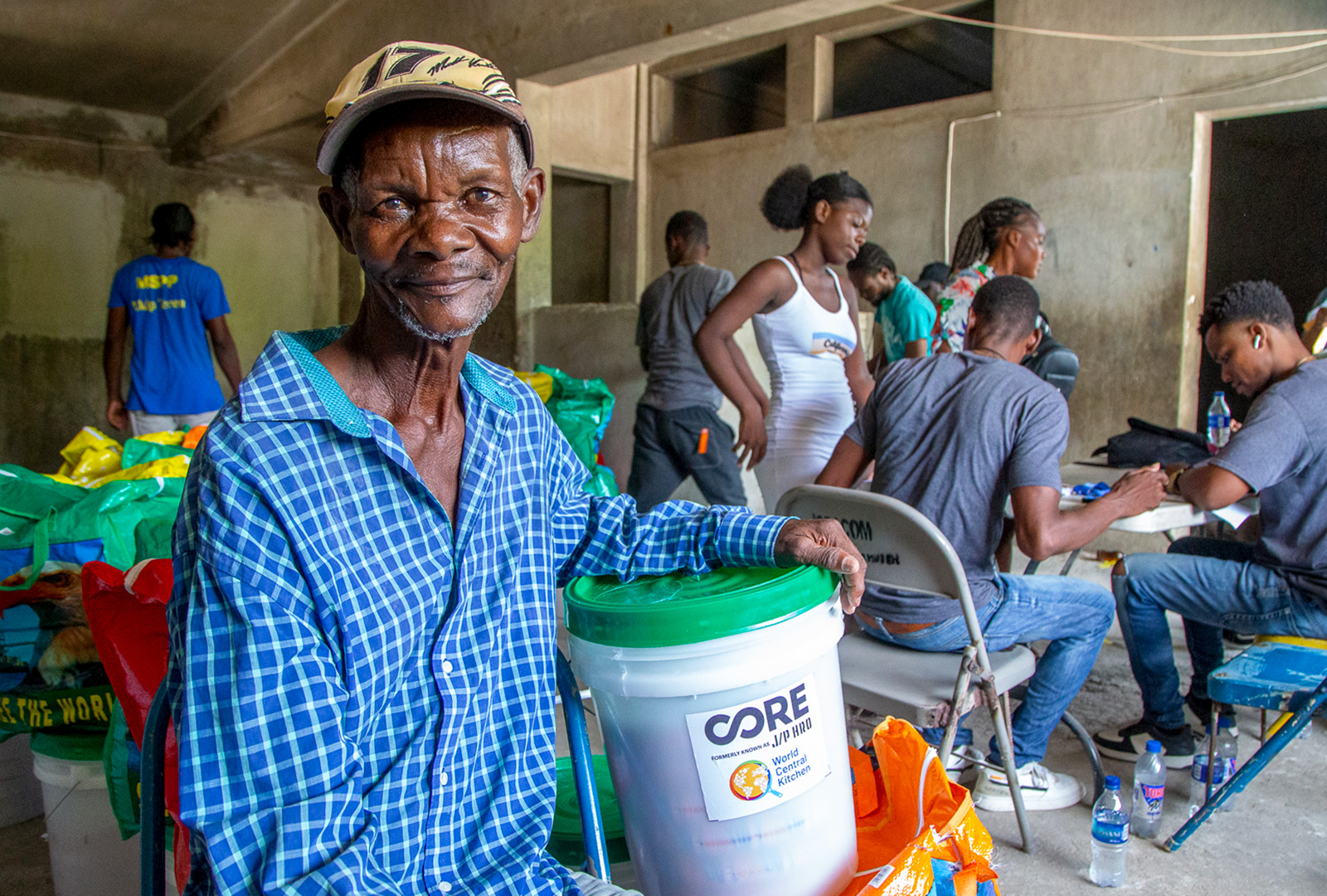 A man takes a picture after receiving his food kit in Haiti.