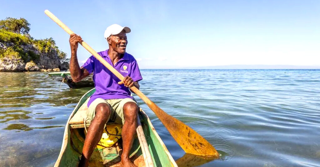 CORE Haiti Beneficiary photo rowing in a small canoa.