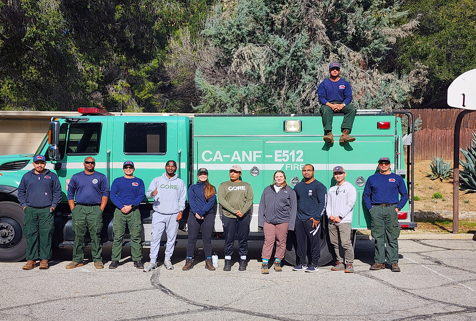 CORE staff and members of the US Forest Service pose for a picture in front of a large Forest Service truck.