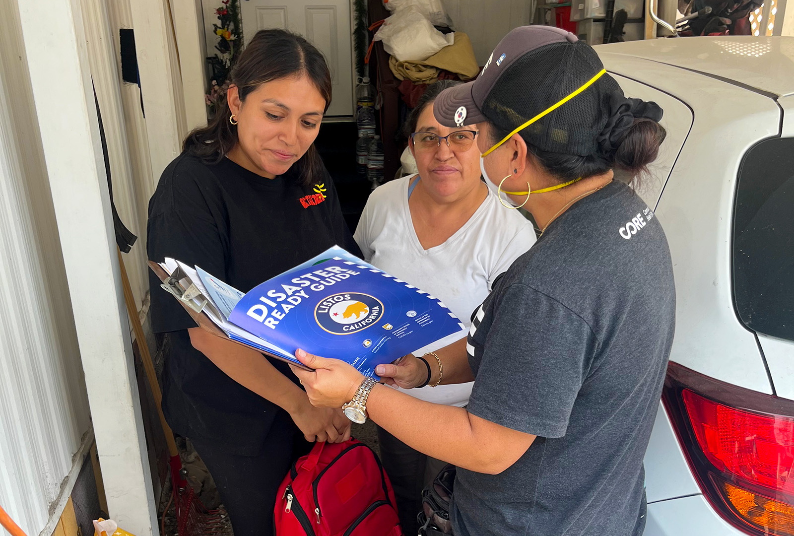 A member of CORE's staff meets with residents of Big Bear Lake and show them emergency evacuation resources.