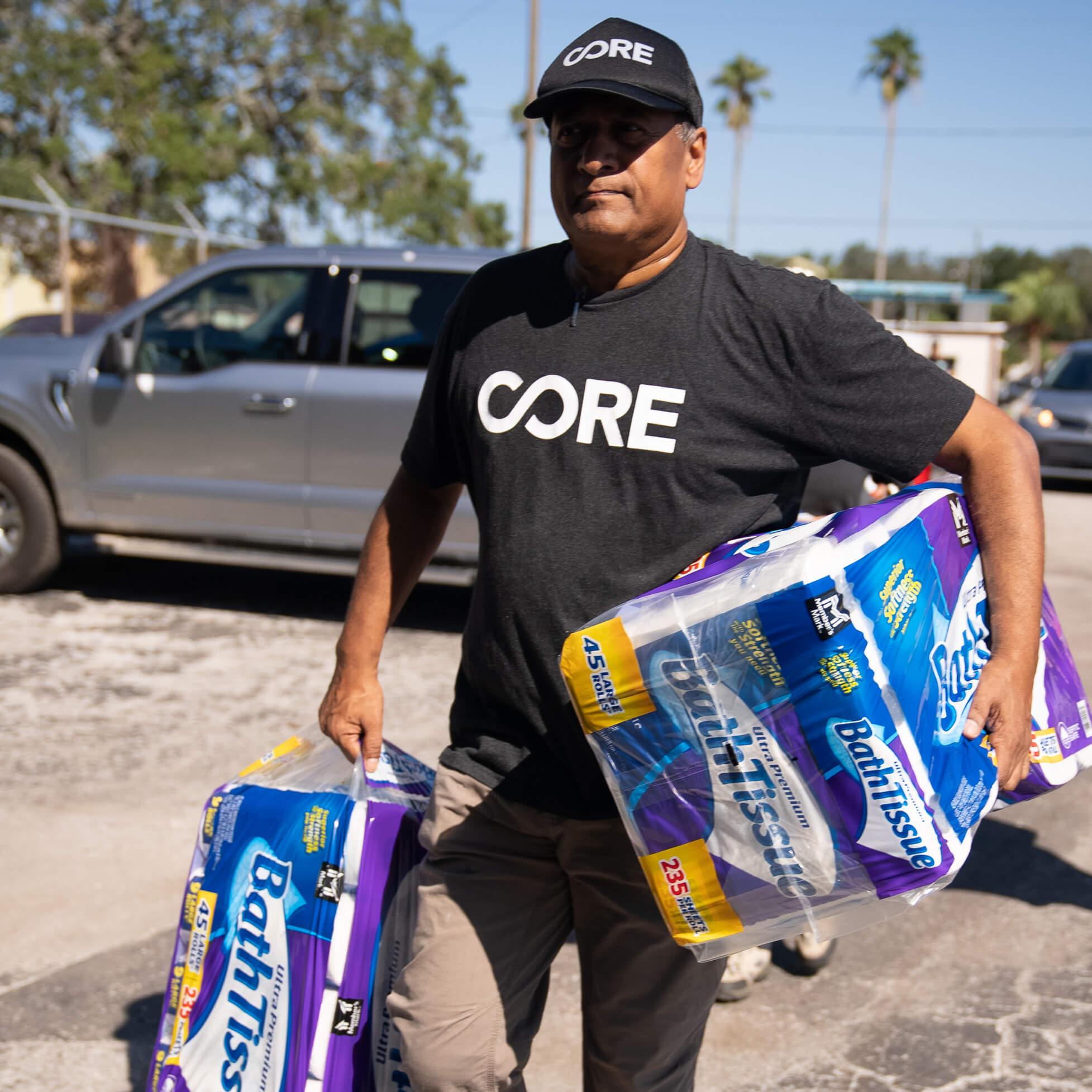 CORE staff carries packs of toilet paper in each arm as part of our response to hurricane milton in Florida