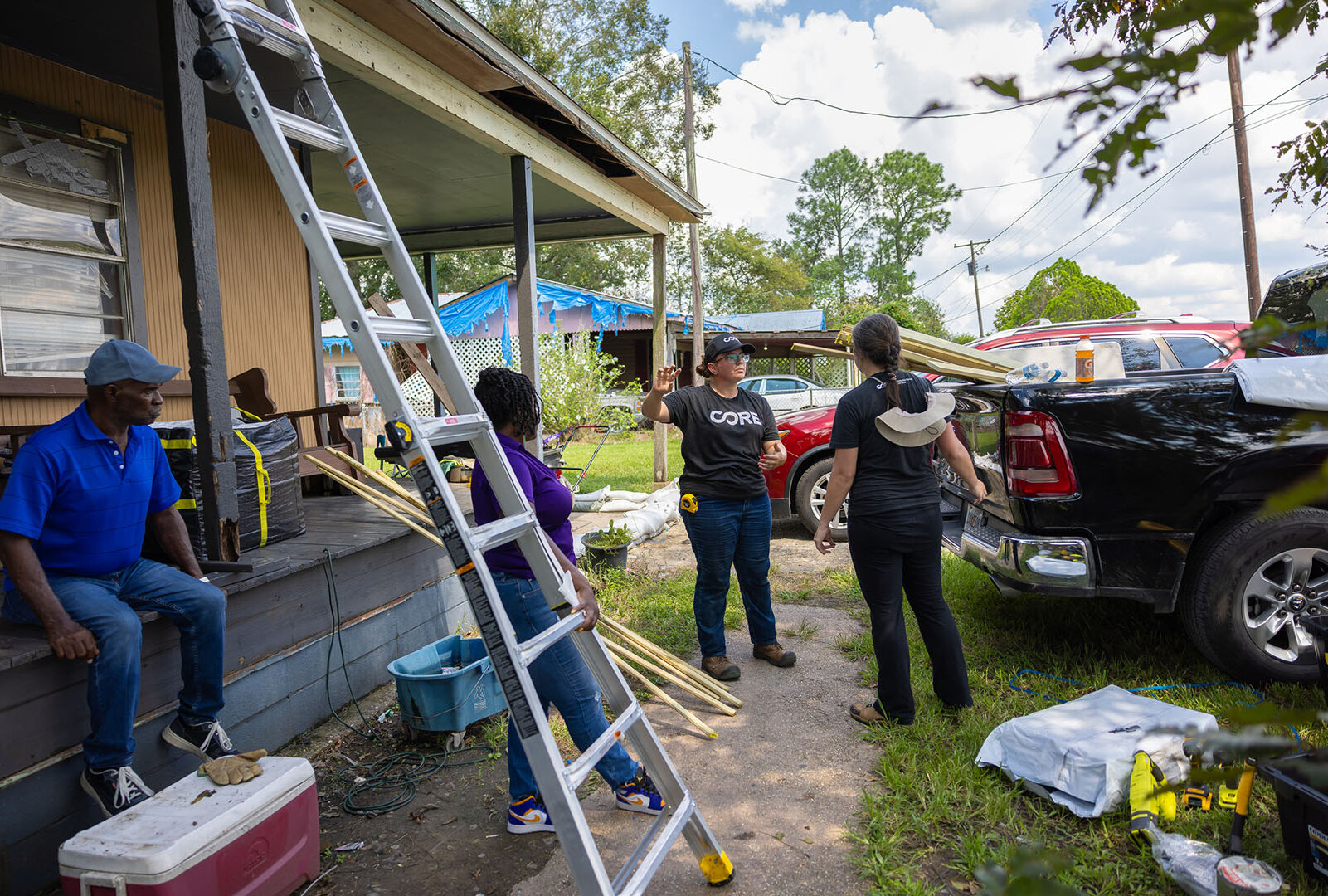 CORE team and other partners stand in front of mobile home to discuss action.