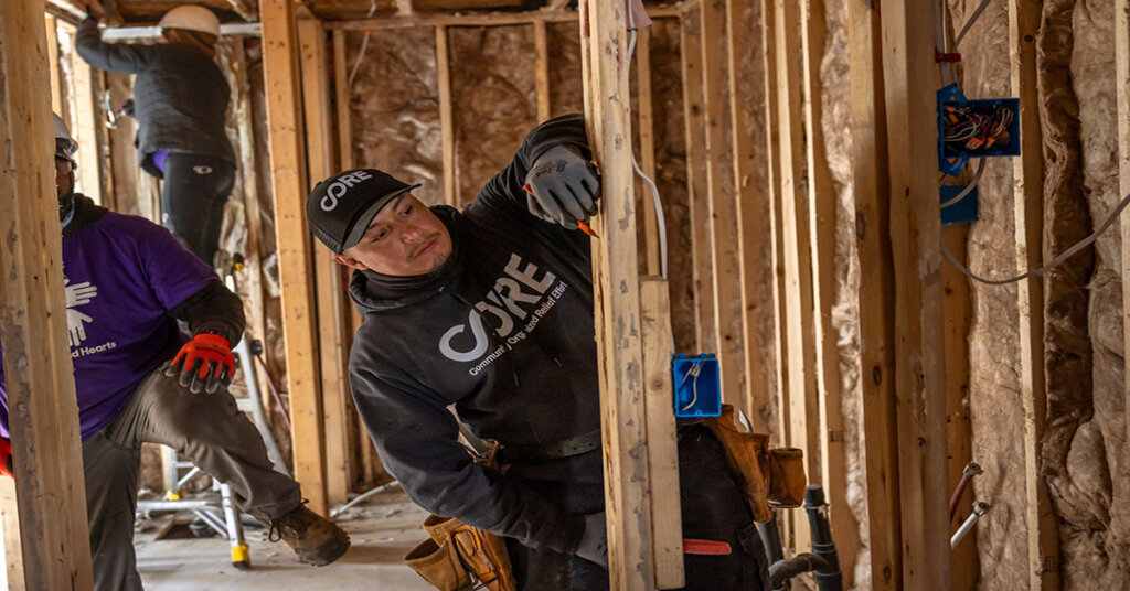 A member of CORE's staff working on the wood frame of a home in North Carolina.