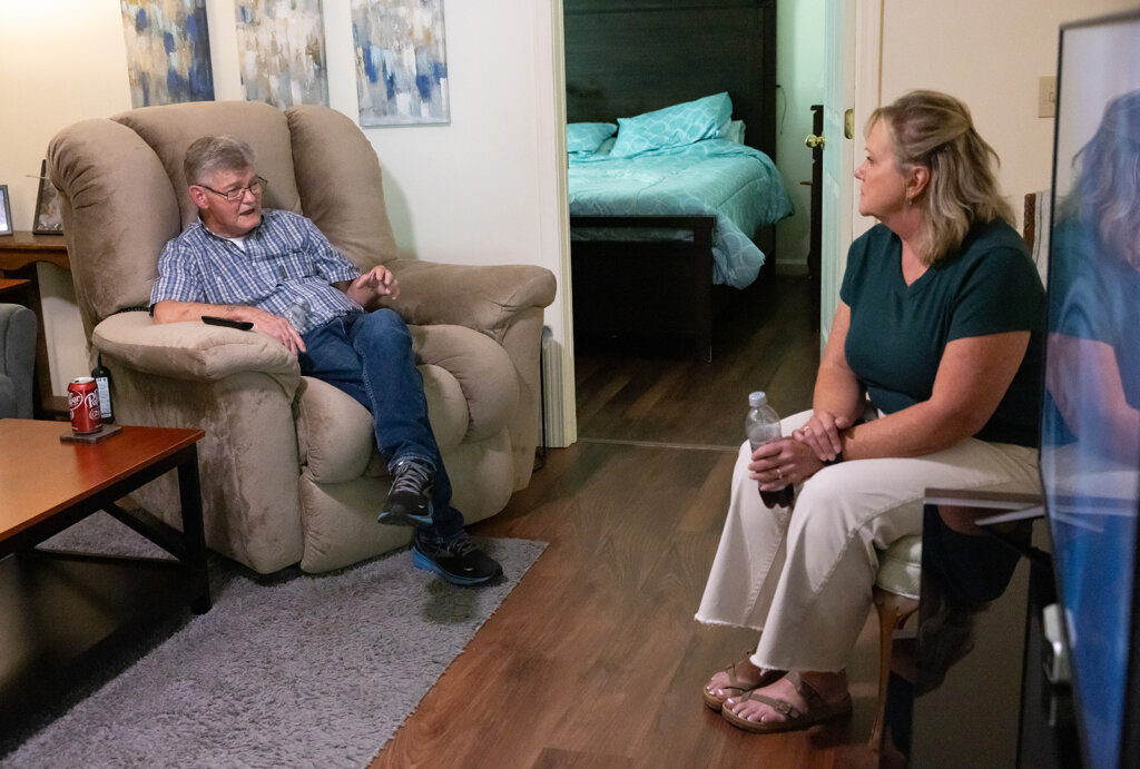 Bill Gross sits with Kim inside his new home.