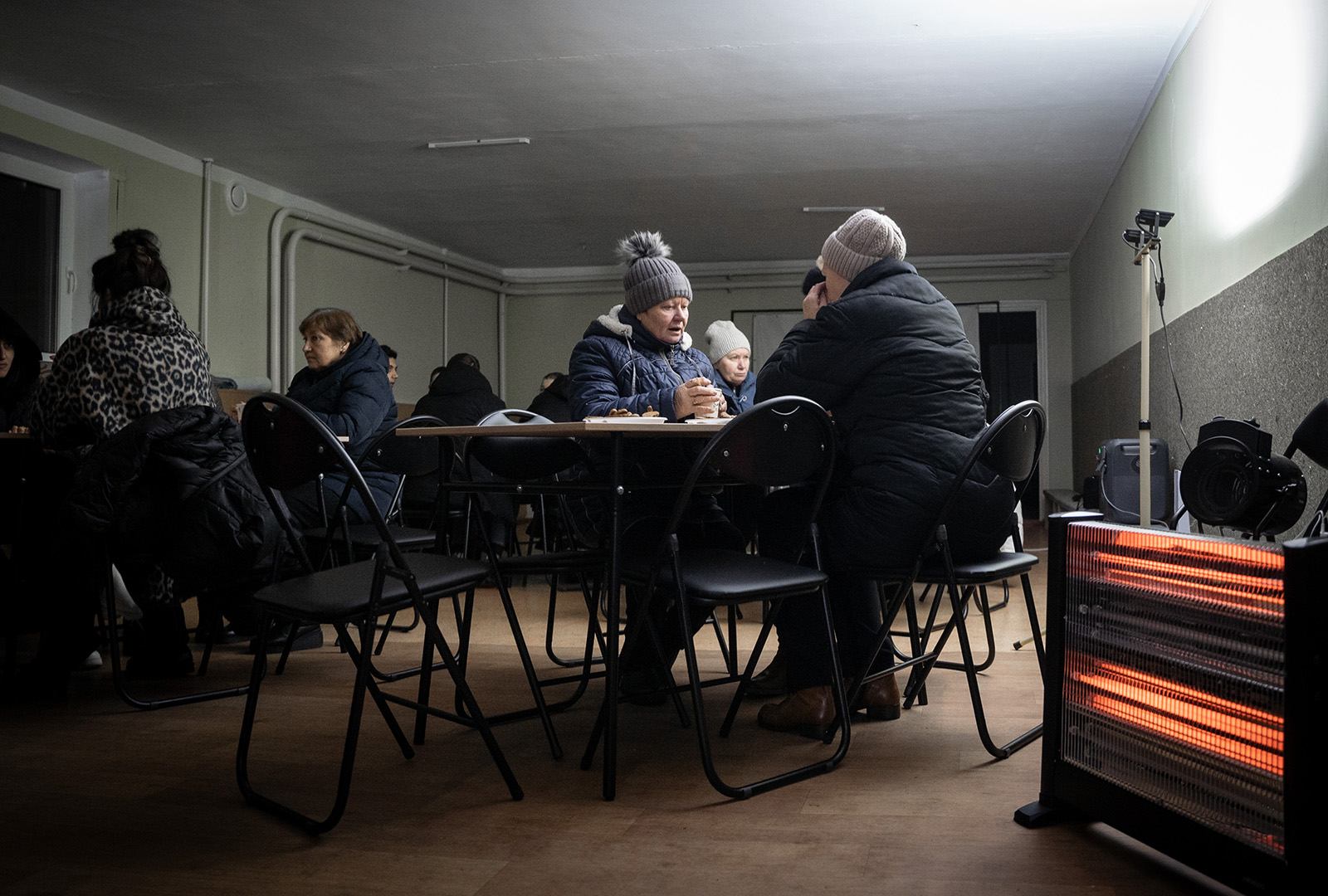 Mykolaiv residents in December 2023, utilize a CORE supported “Invincibility Shelter,” a safe place to gather, charge phones, sit by a heater, or enjoy a warm drink.