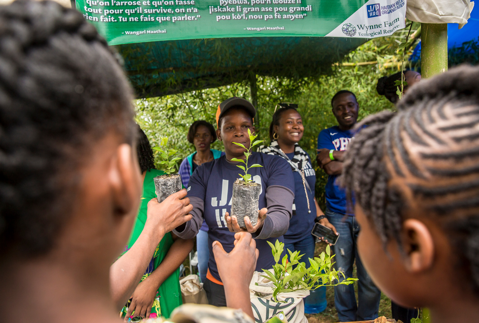 Staff hand out seedlings for tree planting at an Earth Day event in April 2019. Environmental resiliency in Haiti has been a focal point of CORE’s work since 2015, with the launch of Haiti Takes Root along with multiple sustainable agroforestry and fishing initiatives to date.