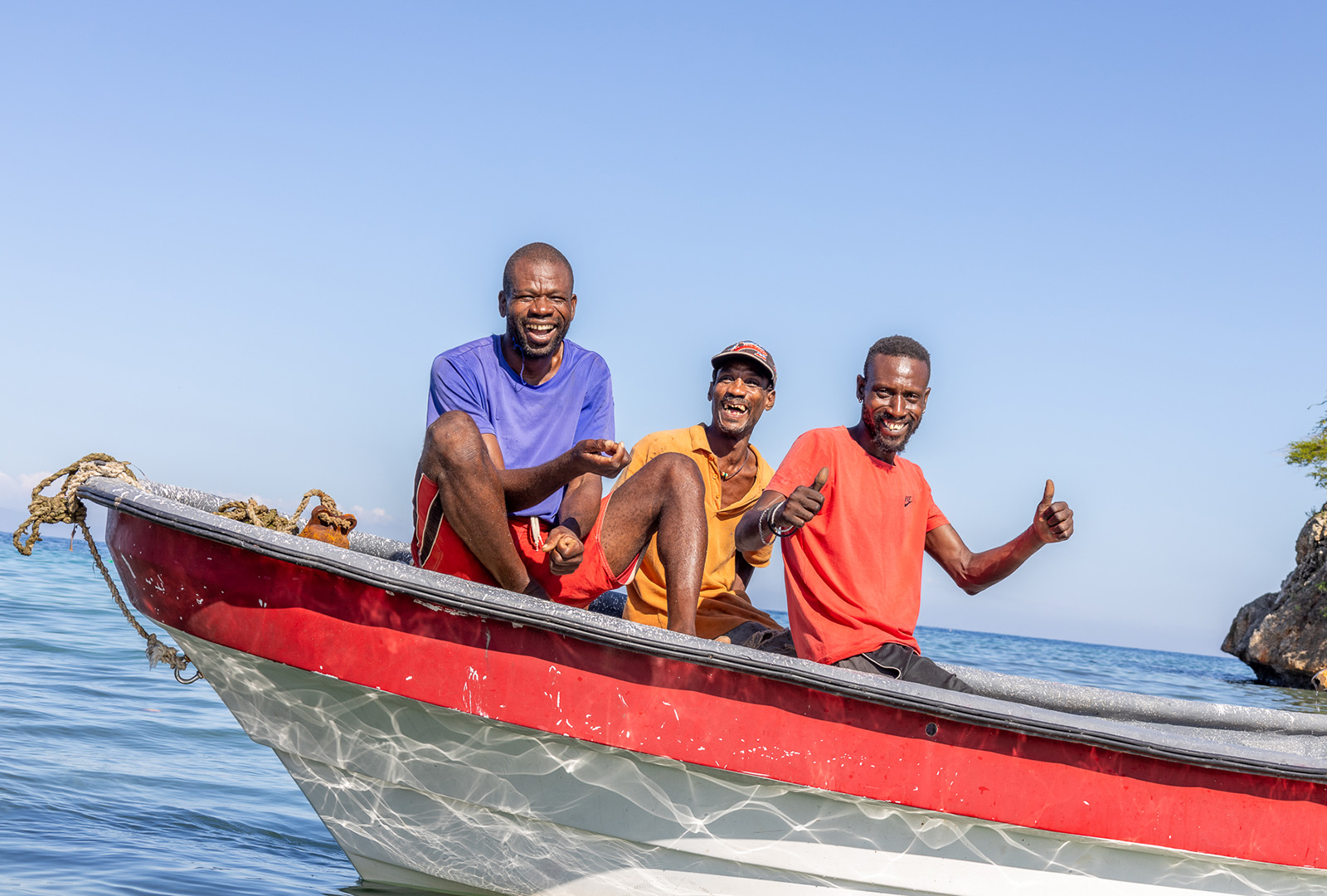 A group of fishermen participating in CORE’s Ecosystem Based Adaption (EBA) program pose in their boat in Haiti’s Nippes Department in December 2023. As part of the EBA program CORE works with local fishers to develop a participatory management plan to reduce overfishing in shallow waters to preserve the ecosystem, encourage the renewal of key fish species, and increase fisher income.