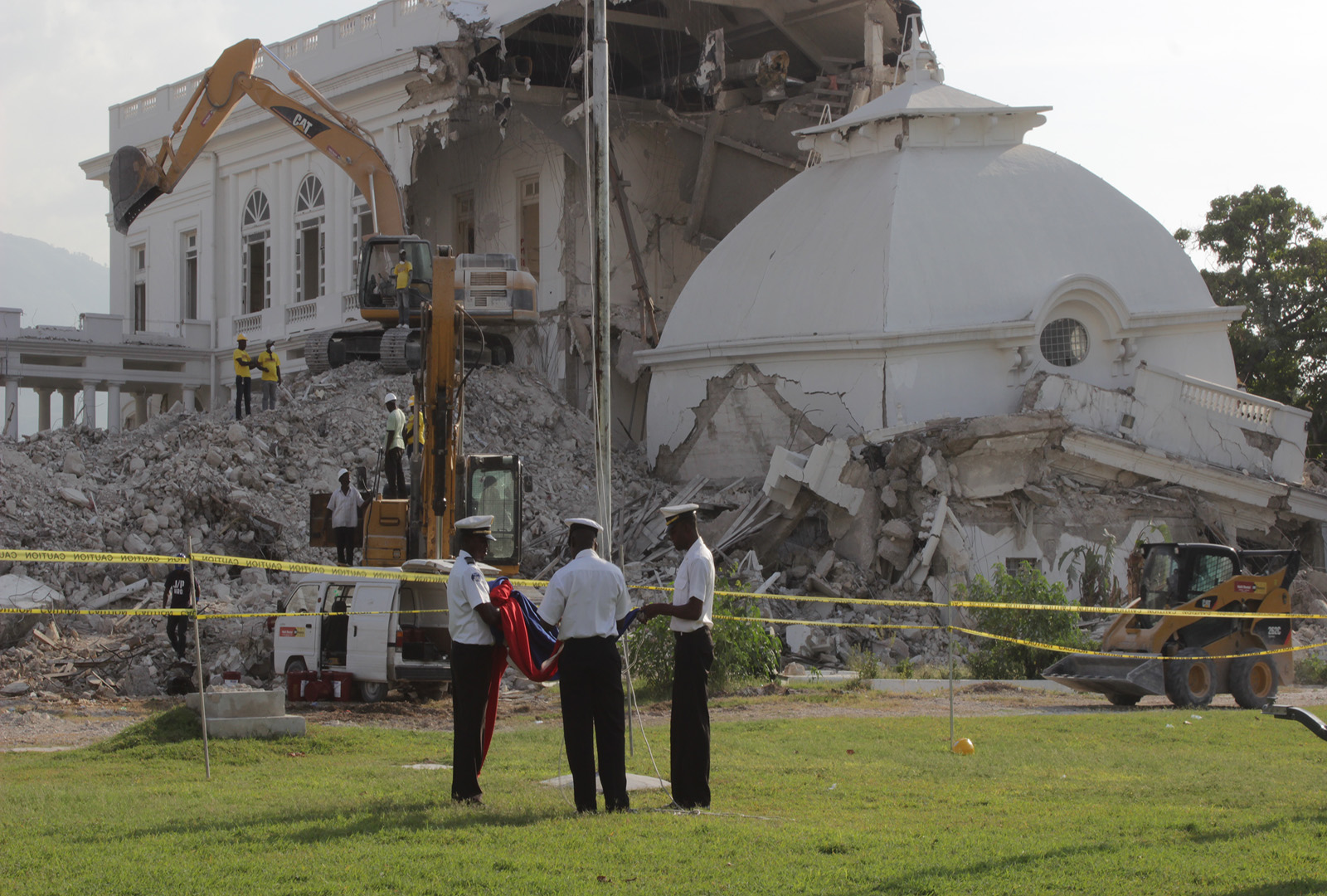 The Haitian flag is retired at the Haitian National Palace as demolition gets underway in September 2012. With extensive prior experience in rubble removal work, the Haitian Government tasked J/P HRO with handling the demolition of the official residence of the Haitian President that was severely damaged by the earthquake.