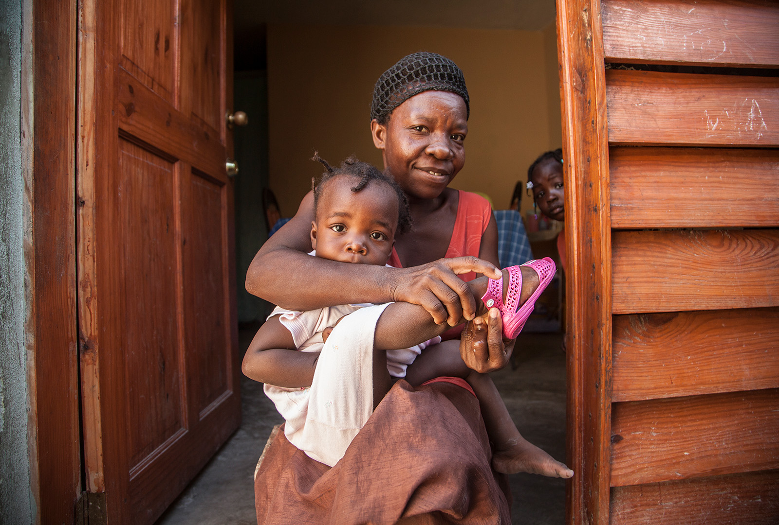 Chèrefrère François and family are in her new home built by J/P HRO in November 2013, after three years living in the Petionville Club Camp. J/P HRO assisted displaced Haitians by building new homes, repairing and retrofitting damaged homes, and through rental support. In early 2014, the Petionville Club Camp closed following the successful relocation of all residents.