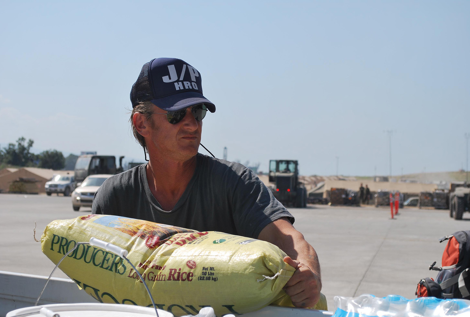 CORE founder Sean Penn loads rice donated by J/P HRO and the Salvation Army onto a US military transport bound for Cap Haitien in February 2010.  Seeing the suffering in Haiti on the news motivated Sean to gather medical supplies to fly into Haiti shortly after the earthquake. From there, J/P HRO soon supported the 82nd Airborne Division in administering the camp, taking full responsibility for it as they withdrew.